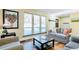 Cozy living room with hardwood floors, large windows, and comfortable seating at 30633 Kings Valley Dr, Conifer, CO 80433