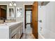 Bathroom with double vanity, tiled floor, tub and shower at 1001 E 17Th Ave # 12, Denver, CO 80218