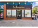 Commercial building facade featuring la Bouche wine bar with black paint, gold lettering, and windows at 1001 E 17Th Ave # 12, Denver, CO 80218