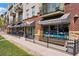 Inviting commercial building featuring Watercourse Foods restaurant with outdoor seating, and balconies at 1001 E 17Th Ave # 12, Denver, CO 80218