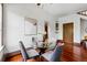 Bright dining area with a glass table, hardwood floors, and stylish decor, great for Gathering meals and entertaining at 1001 E 17Th Ave # 12, Denver, CO 80218