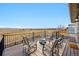 Spacious back deck featuring a cozy fire pit and outdoor seating with views of the plains at 10741 Idalia Way, Commerce City, CO 80022