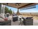 Serene back patio with comfortable outdoor seating, a gas grill, and views of the plains at 10741 Idalia Way, Commerce City, CO 80022