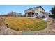 Well-maintained backyard featuring a large, grassy lawn, patio, and upper deck at 10741 Idalia Way, Commerce City, CO 80022