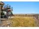 A vast backyard with a patio area, offering scenic views of the surrounding landscape at 10741 Idalia Way, Commerce City, CO 80022