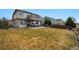 A spacious backyard, highlighted by a patio and spiral staircase to an upper deck at 10741 Idalia Way, Commerce City, CO 80022