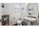 Well-lit powder room with a pedestal sink, modern fixtures, and neutral decor at 10741 Idalia Way, Commerce City, CO 80022
