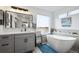 Bright bathroom with a soaking tub, vanity, and modern finishes at 10741 Idalia Way, Commerce City, CO 80022