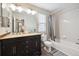 Well-lit bathroom featuring double sinks with an elegant vanity and a shower-tub combination at 10741 Idalia Way, Commerce City, CO 80022