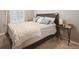 Cozy bedroom featuring a bed with striped bedding, side tables, and soft natural lighting at 10741 Idalia Way, Commerce City, CO 80022
