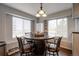Eat in dining area with a barrel-style table base and natural light from the windows at 10741 Idalia Way, Commerce City, CO 80022