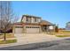 Charming two-story home with a three-car garage and a welcoming front porch at 10741 Idalia Way, Commerce City, CO 80022