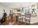Basement kitchen with bar seating, modern lighting, beautiful granite countertops and nice wood floors at 10741 Idalia Way, Commerce City, CO 80022