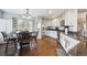 Bright kitchen with stainless steel appliances, gray cabinets, and a dining area with stylish chairs at 10741 Idalia Way, Commerce City, CO 80022