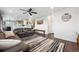 Spacious living room with hardwood floors, modern decor, and an open layout at 10741 Idalia Way, Commerce City, CO 80022
