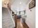 Open-concept home design with carpeted stairs leading to the main-level living area at 10741 Idalia Way, Commerce City, CO 80022