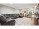 Spacious living room featuring a large sofa and an open-concept design with hardwood flooring at 10741 Idalia Way, Commerce City, CO 80022