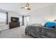 Spacious main bedroom with a ceiling fan, natural light, and carpet flooring at 10741 Idalia Way, Commerce City, CO 80022