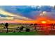 Picturesque sunset view of the fields with dramatic skies and a charming wooden fence at 10741 Idalia Way, Commerce City, CO 80022