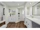 Bathroom features dual vanities, wood flooring, modern fixtures, and recessed lights at 6800 S Pennsylvania St, Centennial, CO 80122