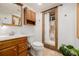 Bathroom with tiled shower, wood vanity and updated features at 6800 S Pennsylvania St, Centennial, CO 80122