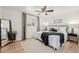 Bright bedroom with a ceiling fan, neutral colors, hardwood flooring, and large windows at 6800 S Pennsylvania St, Centennial, CO 80122