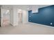 Carpeted bedroom features a large closet, a vibrant accent wall, and natural light at 6800 S Pennsylvania St, Centennial, CO 80122