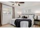 Bright bedroom with a ceiling fan, wooden floor, and stylishly decorated bed at 6800 S Pennsylvania St, Centennial, CO 80122