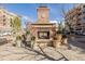 Inviting outdoor fireplace adorned with planters, providing a cozy gathering spot within the SouthGlenn community at 6800 S Pennsylvania St, Centennial, CO 80122