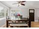 Cozy dining room featuring a rustic wood table, bench seating, and a ceiling fan at 6800 S Pennsylvania St, Centennial, CO 80122