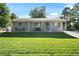 Beautiful single-story home with a lush green lawn and inviting front porch at 6800 S Pennsylvania St, Centennial, CO 80122