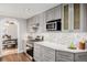 Modern kitchen with stainless steel appliances, light grey cabinets, and access to the dining room at 6800 S Pennsylvania St, Centennial, CO 80122