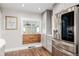 Well-lit kitchen featuring stainless steel refrigerator and a cozy breakfast nook by the window at 6800 S Pennsylvania St, Centennial, CO 80122