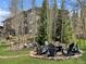 An inviting outdoor firepit with seating surrounded by nature, perfect for gatherings and relaxation at 290 Broken Lance Dr # B104, Breckenridge, CO 80424