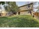 Spacious backyard with a grassy area and trees at 19136 E Milan Cir, Aurora, CO 80013