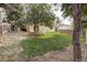 Large backyard with grass, trees, and rock features at 19136 E Milan Cir, Aurora, CO 80013