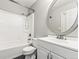 Updated bathroom with white vanity and oval mirror at 19136 E Milan Cir, Aurora, CO 80013