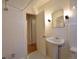 Cozy bathroom features classic white tile, pedestal sink, and a mirrored medicine cabinet at 1409 S Clermont St, Denver, CO 80222