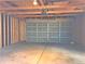 Spacious garage features an insulated door, and unfinished interior, ready for customization at 1409 S Clermont St, Denver, CO 80222