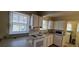 Well-lit kitchen with white appliances and a bright view to other rooms at 1409 S Clermont St, Denver, CO 80222