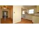 Bright kitchen featuring white cabinetry and appliances, and views to other rooms at 1409 S Clermont St, Denver, CO 80222