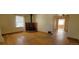 Inviting living room featuring hardwood floors, a brick fireplace, and bright, natural light at 1409 S Clermont St, Denver, CO 80222