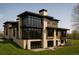 Modern home with multiple balconies, large windows, and beautiful landscaping at 90 Meade Ln, Englewood, CO 80113
