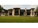 Beautiful home exterior showcasing modern design, large windows, and manicured lawn at 90 Meade Ln, Englewood, CO 80113
