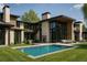Gorgeous backyard featuring a modern pool, fireplace, and outdoor seating area for entertaining at 90 Meade Ln, Englewood, CO 80113