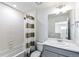 Well-lit bathroom boasts a shower-tub combo with tile surround and a modern vanity with ample counter space at 21761 E 7Th Ave, Aurora, CO 80018