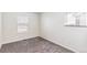Empty bedroom featuring two windows, neutral walls, and carpet flooring at 21761 E 7Th Ave, Aurora, CO 80018