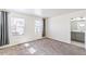 Carpeted bedroom with two windows, gray curtains, and an ensuite bathroom at 21761 E 7Th Ave, Aurora, CO 80018