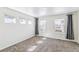 A carpeted bedroom illuminated by three windows is equipped with gray curtains at 21761 E 7Th Ave, Aurora, CO 80018