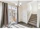 Entryway featuring wood flooring, stairs, and a sliding glass door with gray curtains at 21761 E 7Th Ave, Aurora, CO 80018